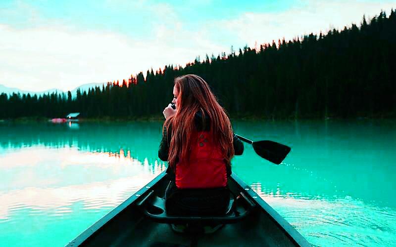 The same canoe photo restyled with a cinematic teal color grade