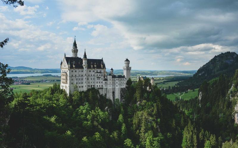 AI-generated image of a hilltop castle rising above a misty forest