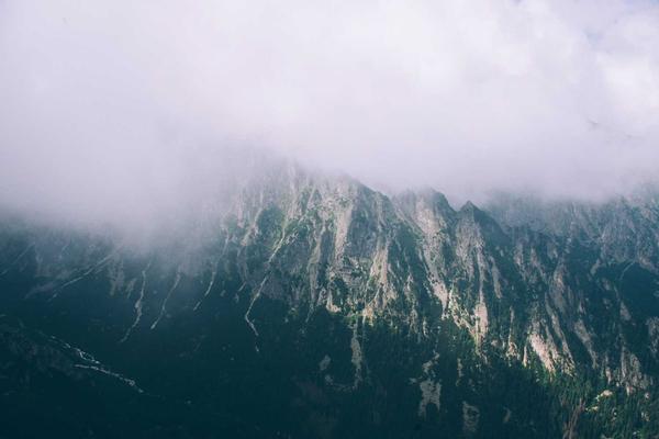Training image: fog rolling over a steep forested mountain ridge