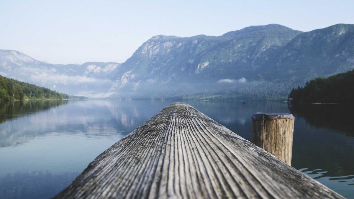 Walkthrough video poster: a wooden dock reaching into a calm mountain lake at dawn